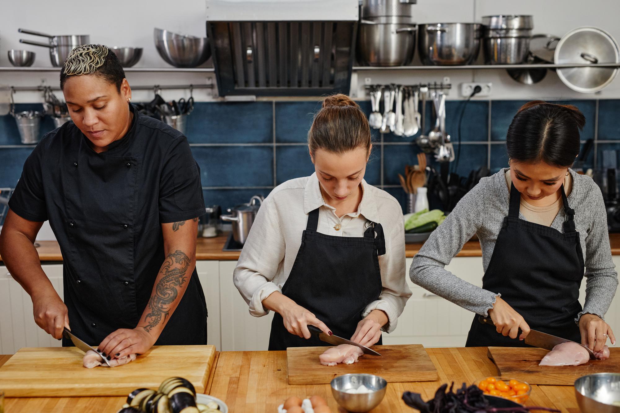 Open kitchen studio with chefs collaborating around a counter
