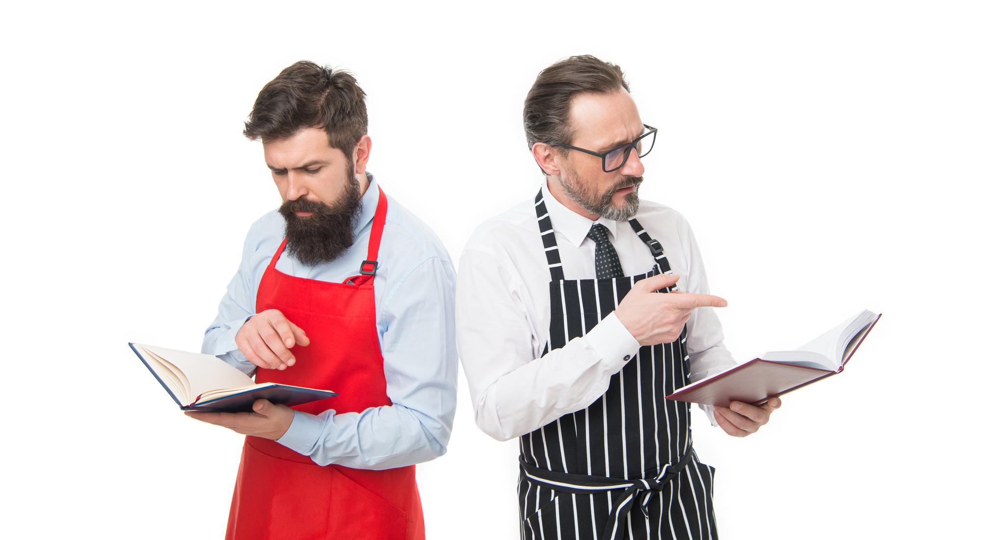 Consultation between chef and restaurateur over menu sheet